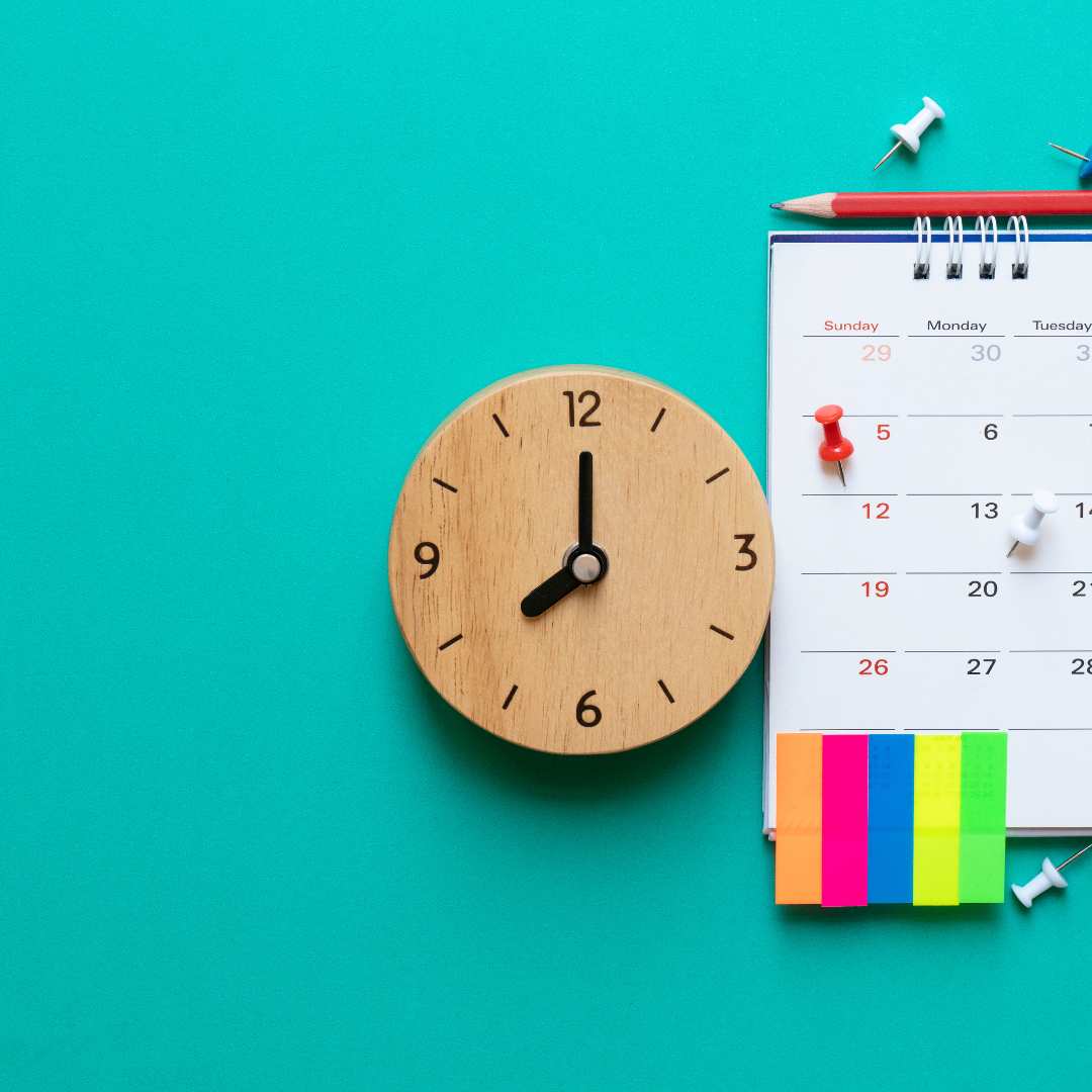 A bright turquoise back ground with a clock and a calendar with a rainbow coloured sticky post its.