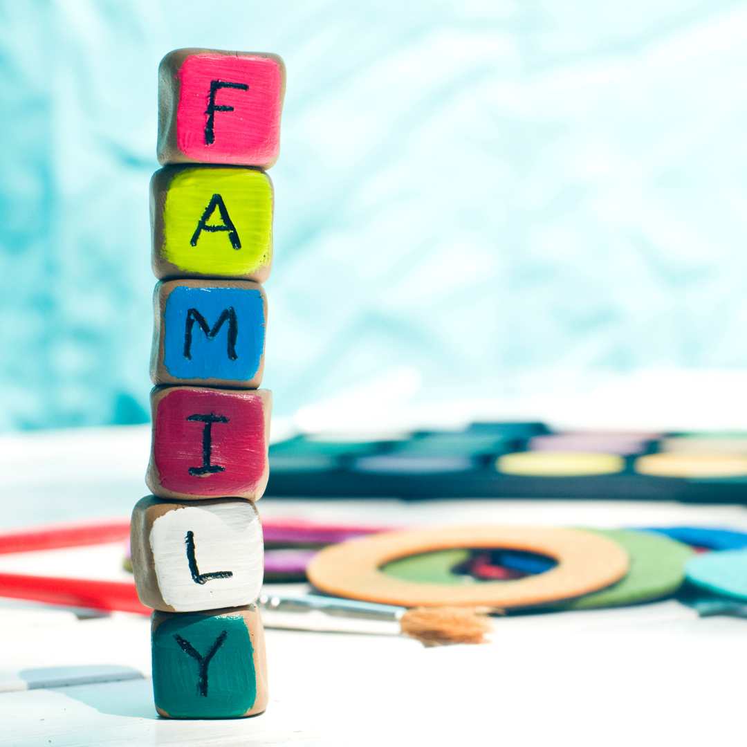A multi-coloured stack of cubes with the letters spelling Famiily in a stack